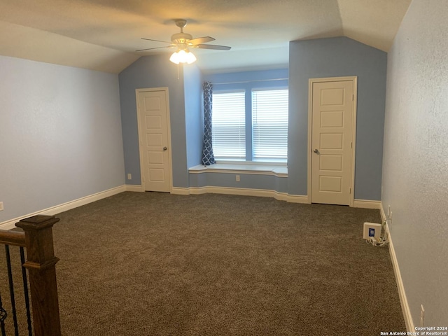 bonus room with dark carpet, vaulted ceiling, and ceiling fan