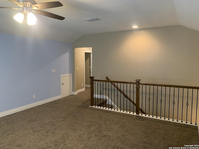 carpeted spare room with ceiling fan and lofted ceiling