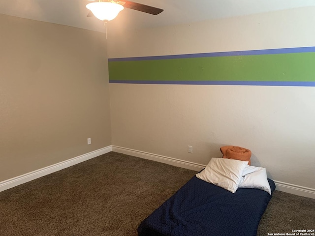 bedroom featuring dark carpet and ceiling fan