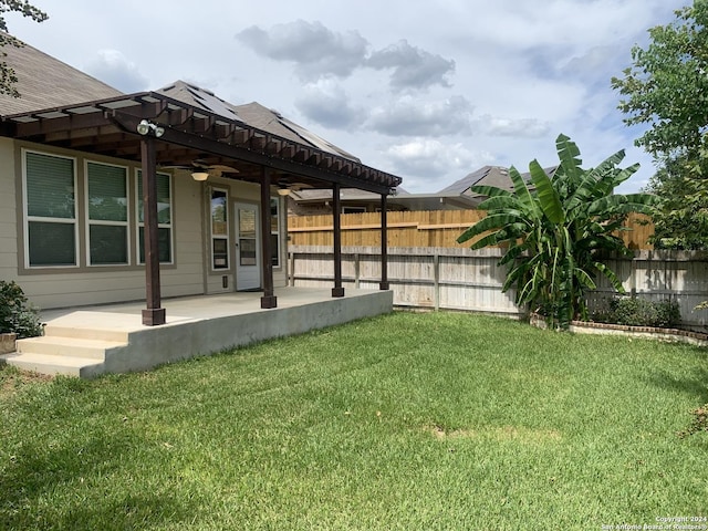 view of yard featuring ceiling fan and a patio