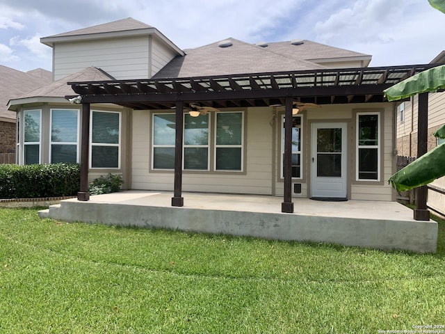 back of property featuring ceiling fan, a yard, a pergola, and a patio