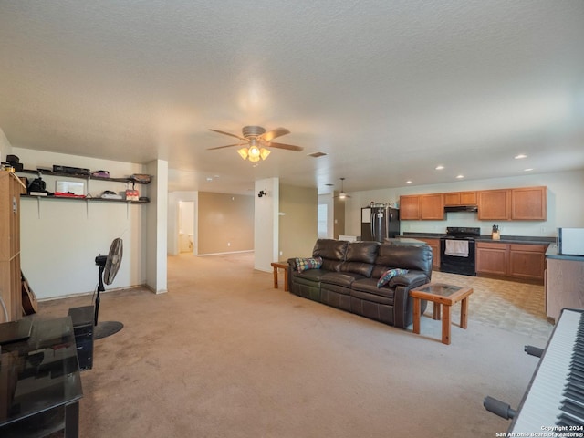 carpeted living room with a textured ceiling and ceiling fan