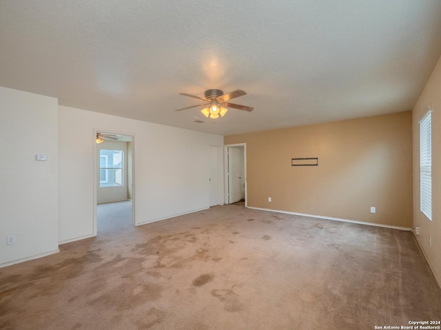 carpeted spare room with a textured ceiling