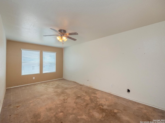 spare room featuring ceiling fan and light colored carpet