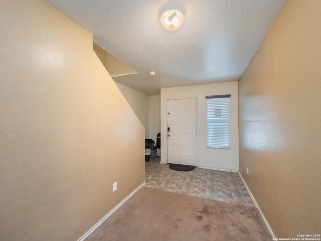 entryway with a textured ceiling