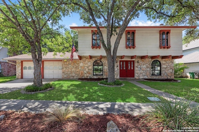 view of front facade with a garage, a front lawn, and french doors