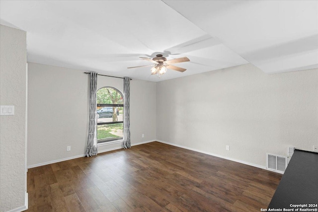 spare room with ceiling fan and dark hardwood / wood-style floors