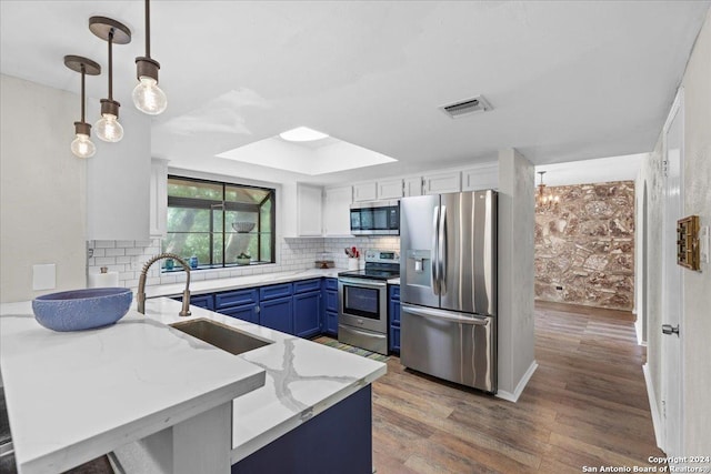 kitchen with stainless steel appliances, blue cabinetry, decorative light fixtures, white cabinets, and sink