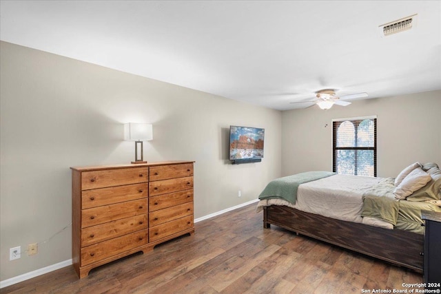 bedroom with ceiling fan and dark wood-type flooring