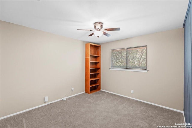 empty room featuring ceiling fan and carpet floors