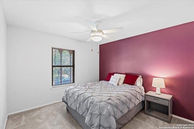 bedroom with ceiling fan and light carpet