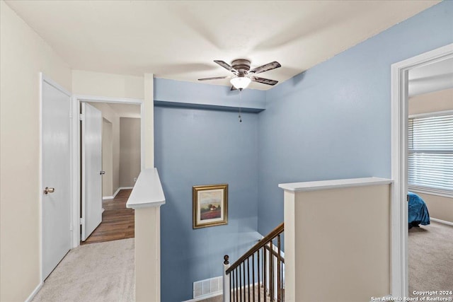 hallway featuring light carpet