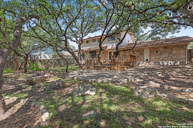 rear view of house featuring a wooden deck