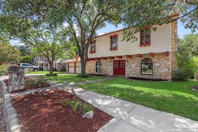 view of front facade with a garage and a front yard