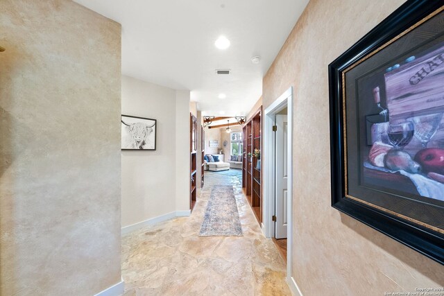 hallway with tile patterned floors