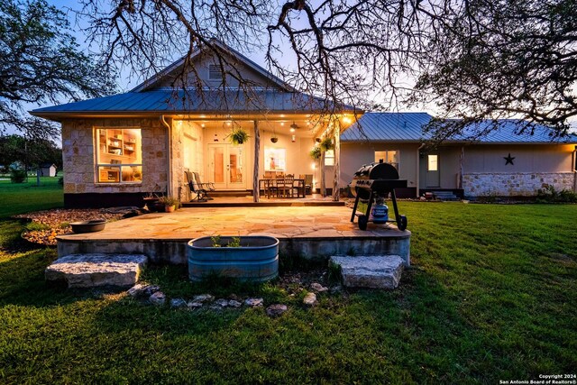 back of house featuring a yard and a patio area