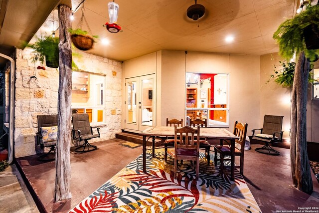 dining room featuring french doors and concrete floors