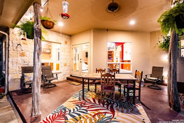 dining space featuring concrete flooring and french doors