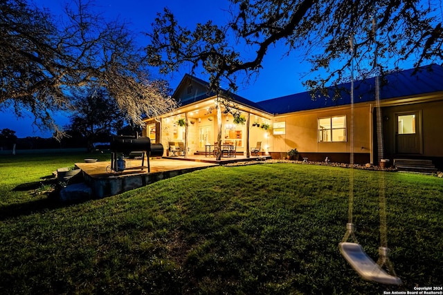 back of property featuring a patio area and a yard