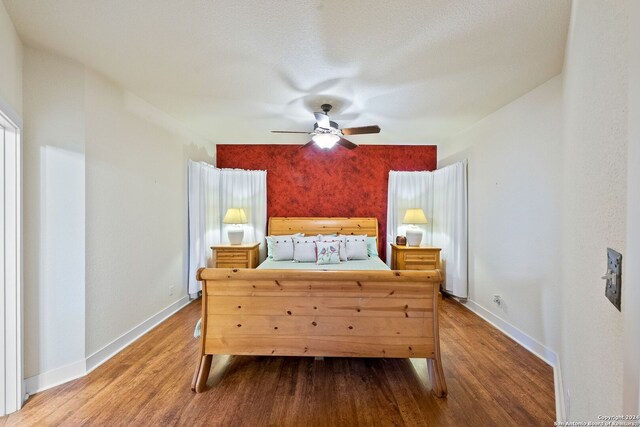 bedroom with ceiling fan and hardwood / wood-style floors