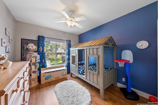 bedroom featuring ceiling fan and hardwood / wood-style flooring