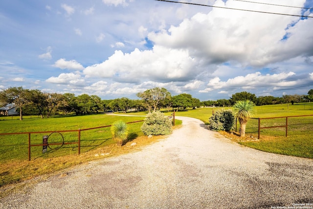 view of road with driveway and a rural view