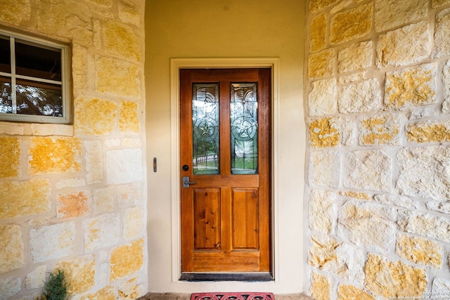 view of exterior entry featuring stone siding