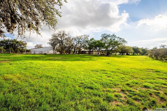 view of yard featuring a rural view and fence