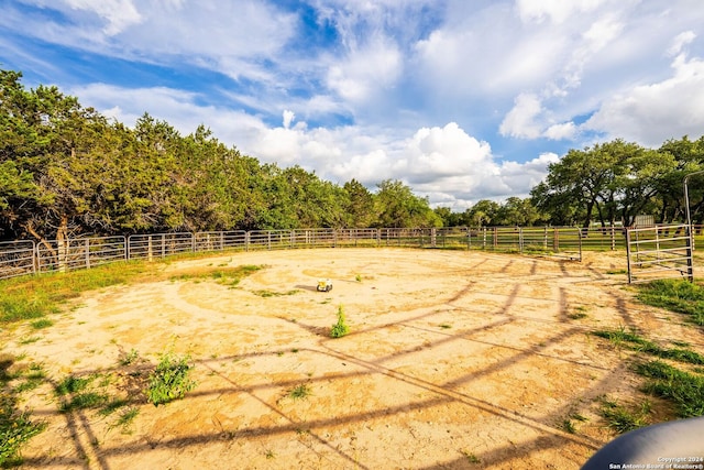 view of yard featuring a rural view and fence