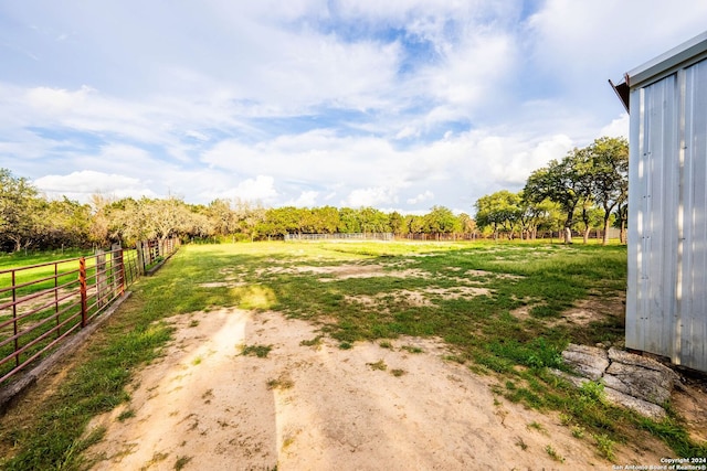 view of yard featuring fence and a rural view