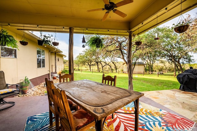 view of patio featuring a ceiling fan, outdoor dining space, and a grill