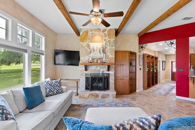 living room featuring a fireplace, tile patterned flooring, ceiling fan, and beam ceiling