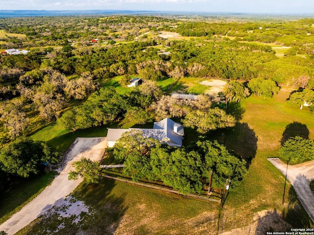 birds eye view of property featuring a forest view