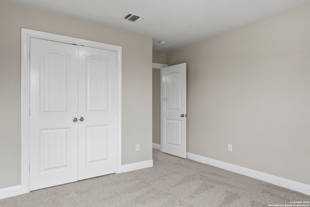 unfurnished bedroom with a closet and carpet