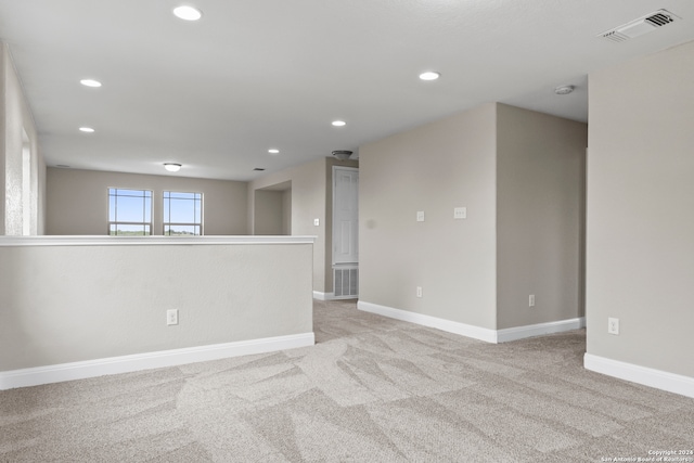 empty room featuring light colored carpet