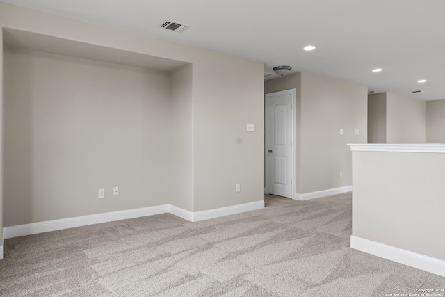 unfurnished room with light carpet