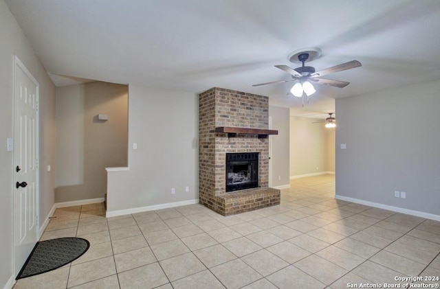 unfurnished living room with a fireplace, ceiling fan, and light tile patterned floors