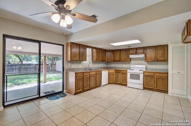 kitchen with white appliances, ceiling fan, light tile patterned flooring, and sink