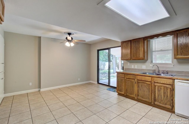 kitchen featuring white dishwasher, ceiling fan, sink, and light tile patterned floors