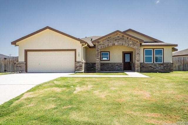 view of front of home featuring a garage and a front lawn