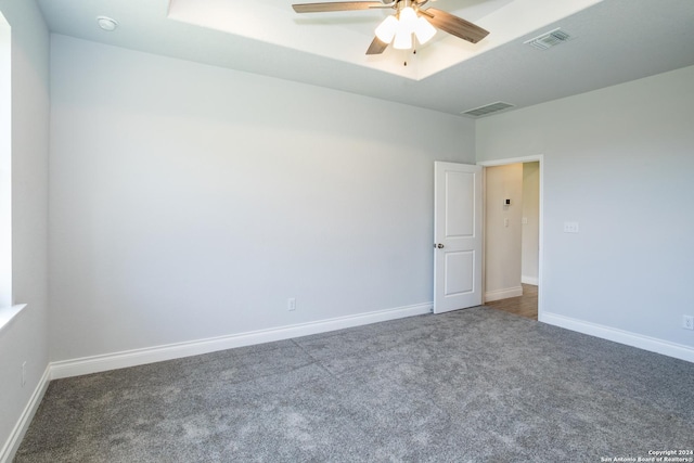 carpeted spare room with ceiling fan