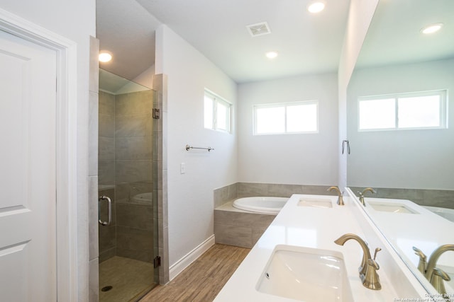 bathroom with separate shower and tub, vanity, and hardwood / wood-style flooring