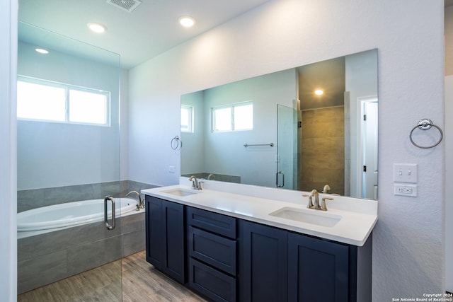 bathroom featuring independent shower and bath and vanity