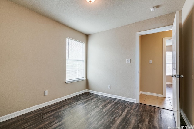 203 Carranza St, San Antonio, TX 78225 - spare room featuring wood finished floors, a smoke detector, baseboards, a textured wall, and a textured ceiling