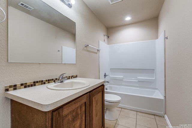 203 Carranza St, San Antonio, TX 78225 - full bath with toilet, vanity, tile patterned floors, bathtub / shower combination, and a textured wall