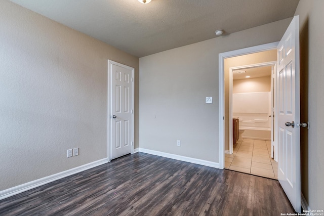 203 Carranza St, San Antonio, TX 78225 - unfurnished bedroom with dark wood finished floors and baseboards