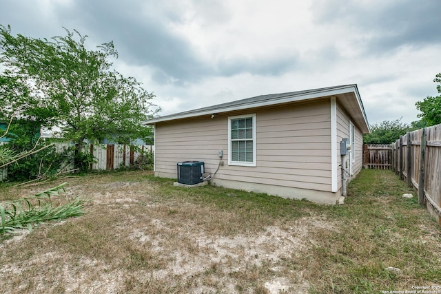 203 Carranza St, San Antonio, TX 78225 - rear view of property with cooling unit and a fenced backyard