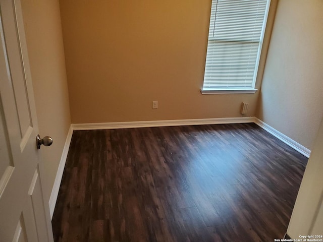 empty room with dark hardwood / wood-style floors