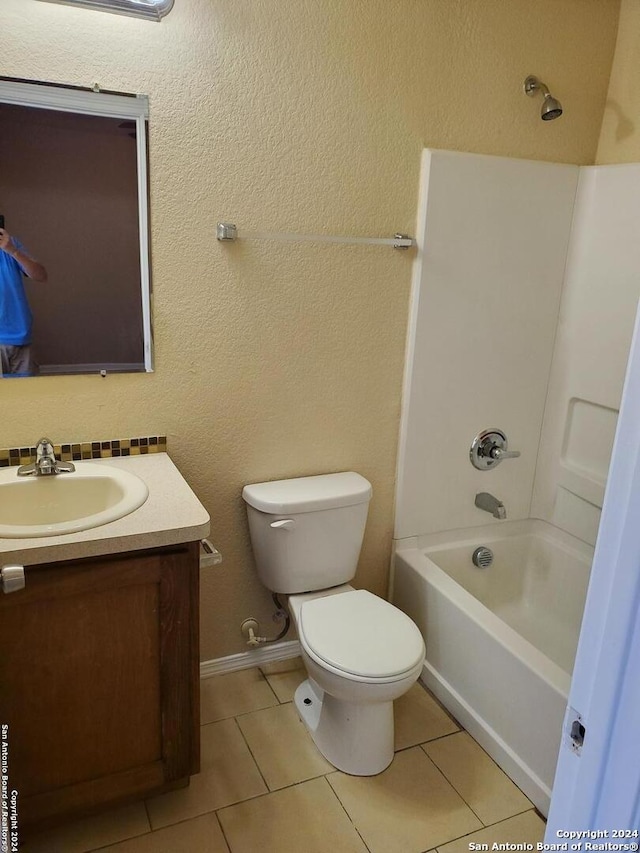 full bathroom featuring tile patterned floors, toilet,  shower combination, and vanity