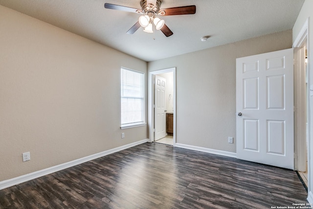 203 Carranza St, San Antonio, TX 78225 - unfurnished bedroom with dark wood finished floors, baseboards, and a ceiling fan